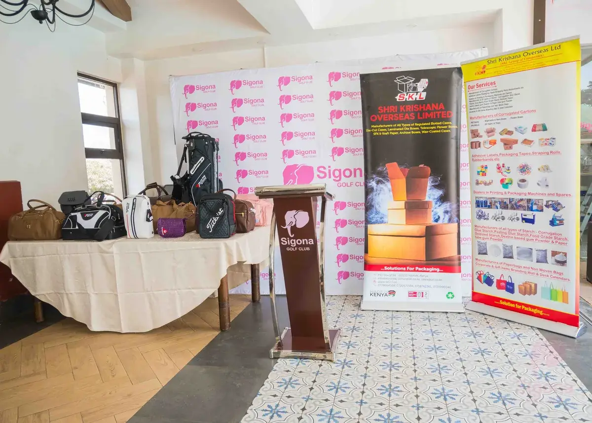 SKL banners and a table of golf bags and holdall prizes at the Sigona Golf Club Ladies Pendant prize-giving